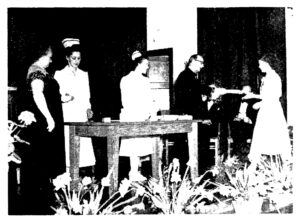 old black and white photo of nursing graduation scene with student receiving diploma on stage