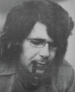 Man approximately 30 years old with glasses and a pipe