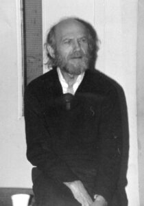 serious young middle-aged man with longer hair and beard