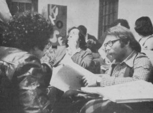 1970s meeting with 3 men sitting in front