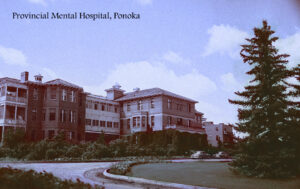 large, imposing old multi-story brick building with sweeping driveway