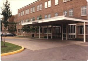 Low-raise institutional brick building, 1970s with front entrance