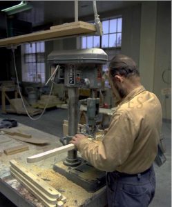 man working with wood at a machine