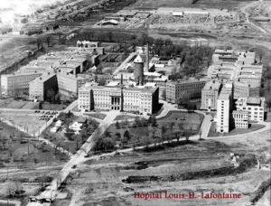 black and white aerial photograph of large institutional complex with main and outlying buildings