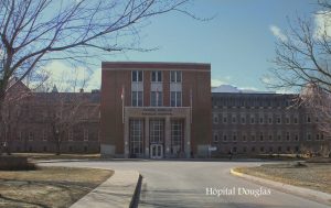 colour photo of modern institutional brick hospital building, post-war architecture 