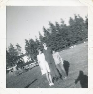 2 young women and one young man standing in playing fields