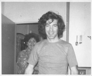 women and man standing in house kitchen
