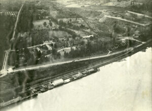 aerial photos of large institution and body of water from a tilted angle