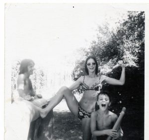 2 women and a young boy in bathing suits playing