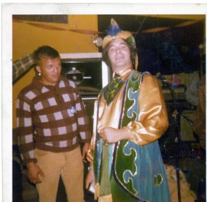 2 men standing next to each other at a party
