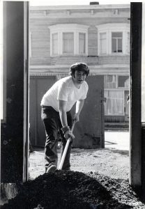 man with shovel digging pile of dirt